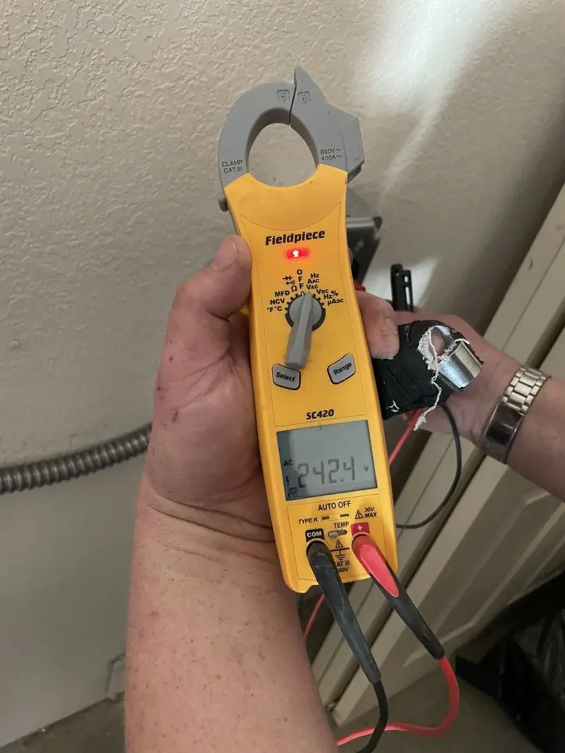 Voltage testing with clamp meter during Whole House Surge Protector in Kings Park West